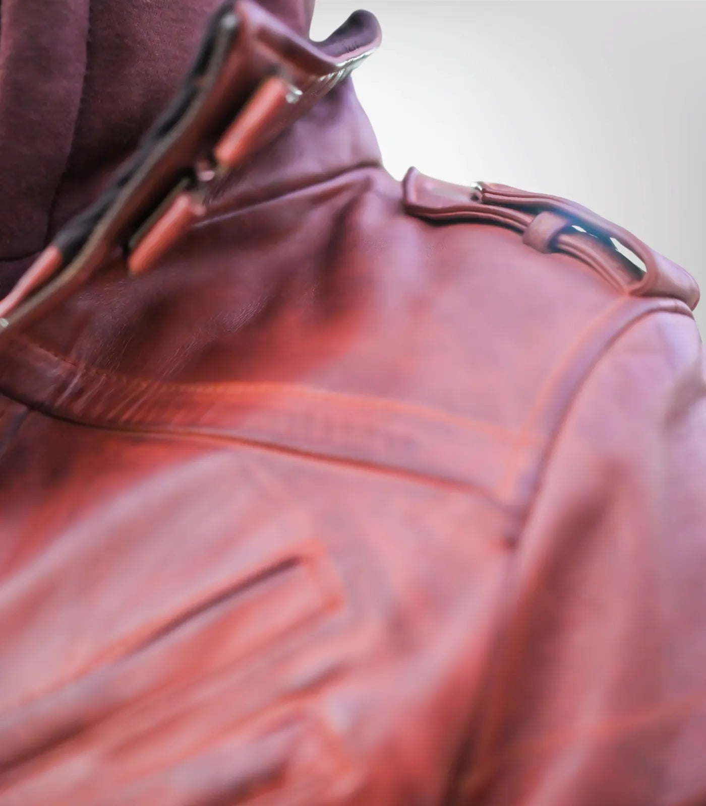 Close-up view of hood design and stitching details on men’s tan bomber leather jacket